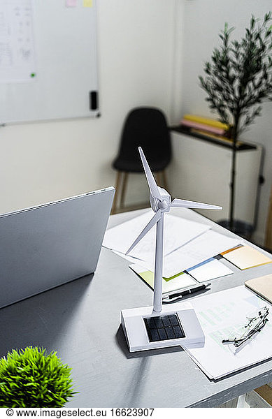 Wind turbine shaped electric fan standing on office desk