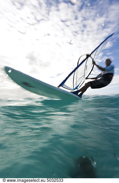 Windersurfer surfing across sea