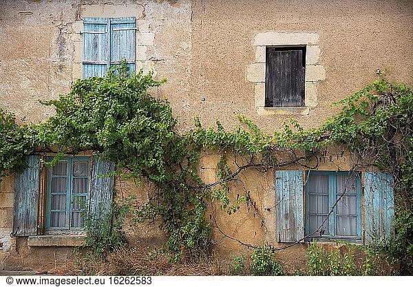 Window with old blue shutters in France