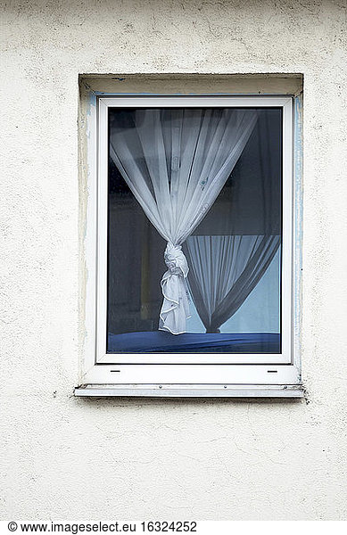 Window with tied curtain