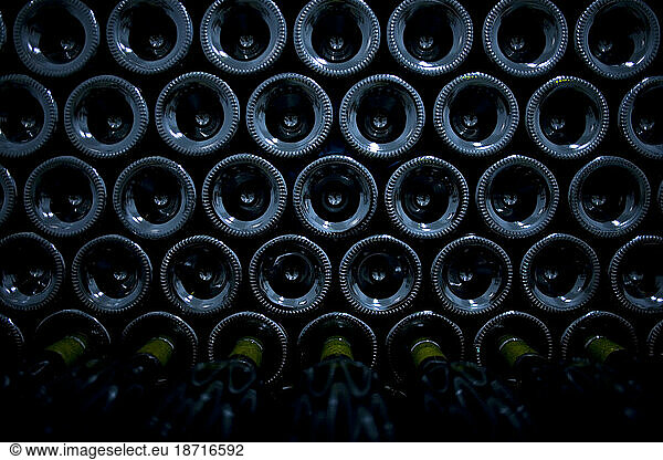 Wine bottles sit stacked in Taramilla winery in Prado del Rey  Cadiz province  Andalusia  Spain.