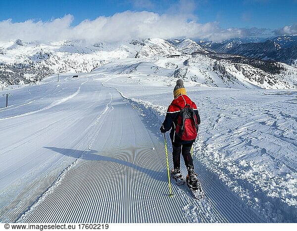 Winter landscape  snowshoe hiker on the way down from Lawinenstein  Tauplitzalm  Styria  Austria  Europe