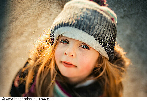 Winter portrait of a 5 years old girl looking at the camera