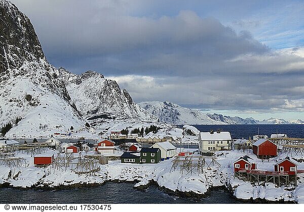 Wintery  Nordic landscape with red houses  rorbuer  sea  mountains  snow  Hamnøy  Nordland  Lofoten  Norway  Europe