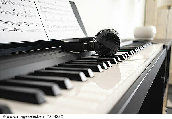 Wireless headphones on piano keyboard