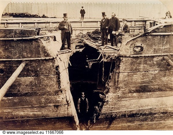 Wolf  mail paddle steamer in dry dock  man stands in the'v' shaped split in its starboard bow