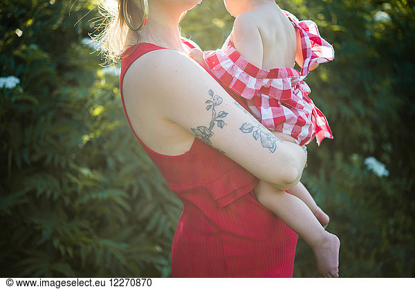 Woman and baby girl in garden