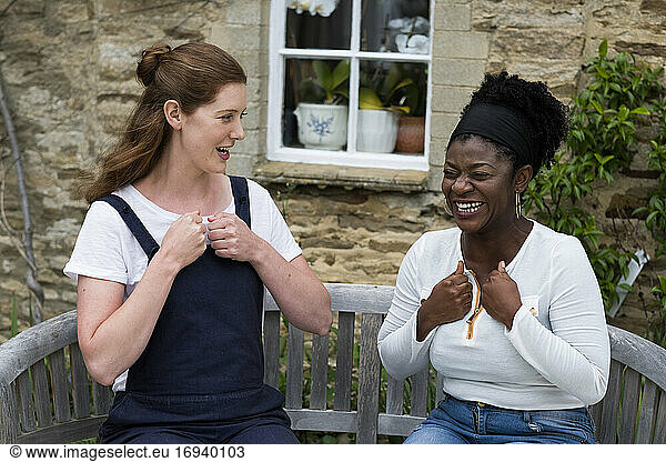 Woman and female therapist talking in a garden.