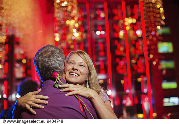 Woman and man embracing in nightclub