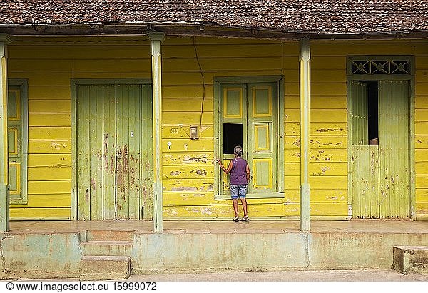 Woman at an old wooden house. Baracoa  Cuba.