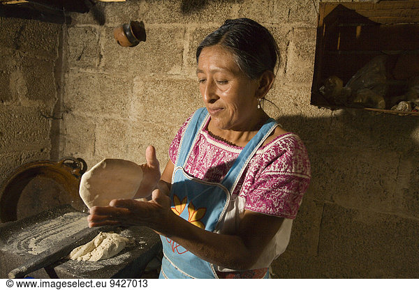 Woman baking tortillas  village of San Miguel  Cuetzalan  Puebla  Mexico