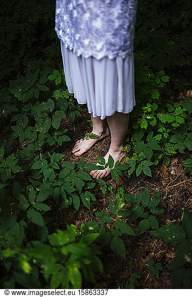 woman bare feet in the forest