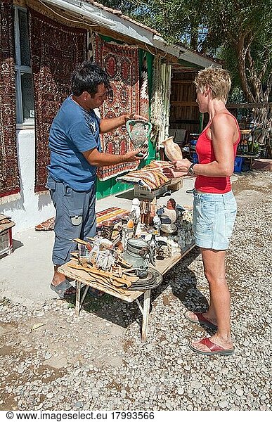 Woman bargaining  haggling  small souvenir shop  souvenir dealer  Lycia  Turkey  Mediterranean Sea  Asia