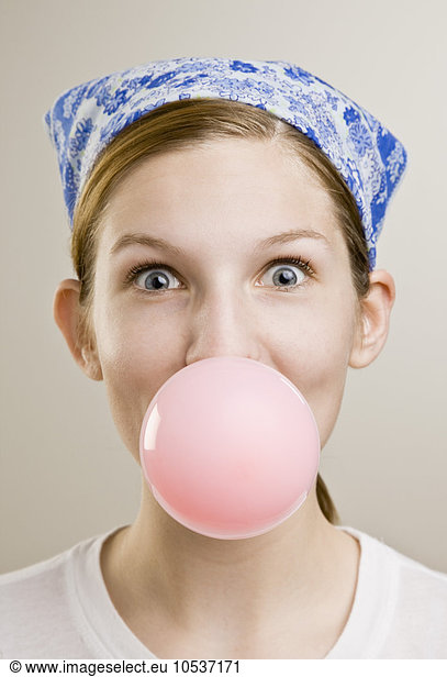 Woman blowing a bubble with gum