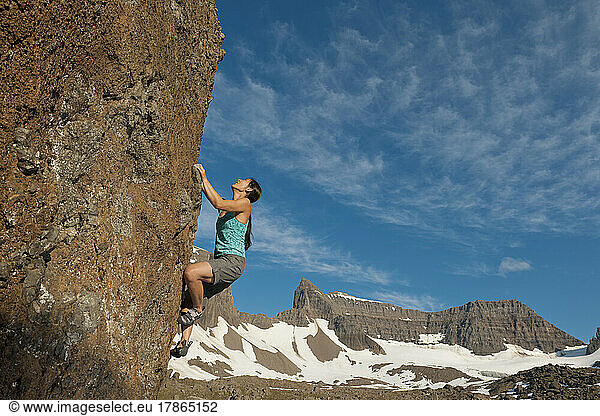 woman bouldering in the remote eastern fjords of Iceland