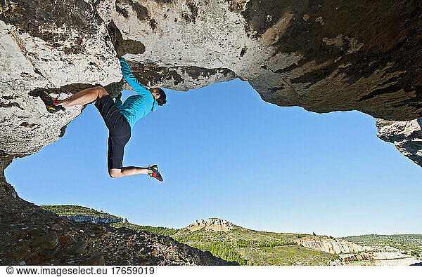 woman bouldering on arch at the French Cote d'Azur