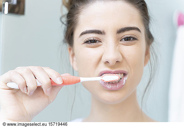 Woman brushing teeth
