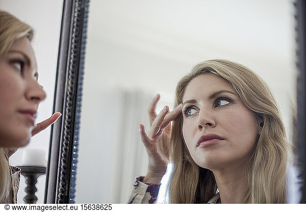 Woman checking make up in a mirror
