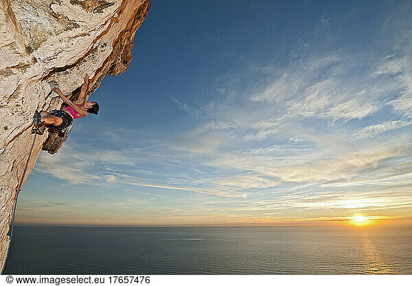 woman climbing rock face at the French Cote d'Azur
