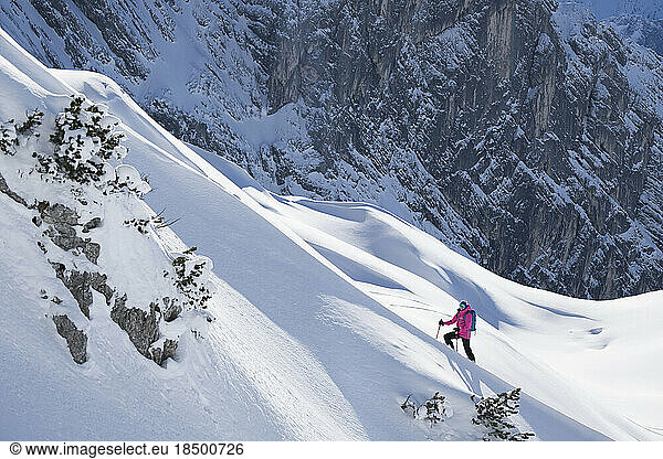 Woman climbing up the ski slope  Bavaria  Germany  Europe