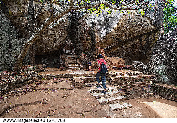 woman climbing up the stairs towards the rock fortress of Sigiriya