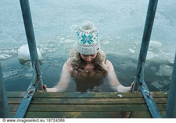 woman cold water swimming in the frozen Baltic Sea