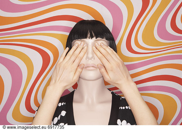 Woman Covering Mannequins Eyes