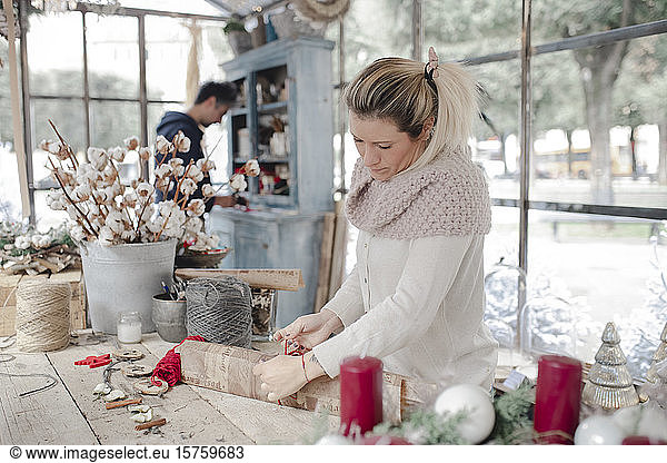 Woman creating Christmas ornaments in shop