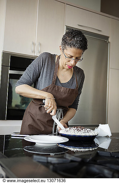 Woman cutting homemade cream tart