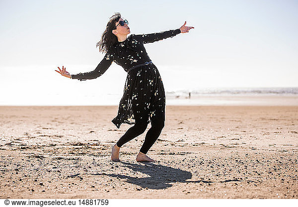 Woman dancing on beach
