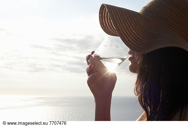 Woman drinking glass of water outdoors