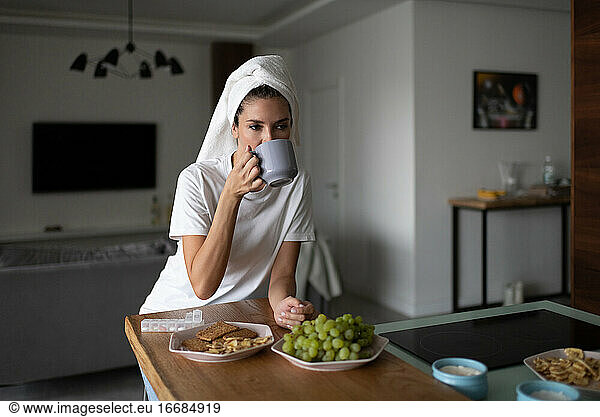 Woman drinking hot beverage after shower