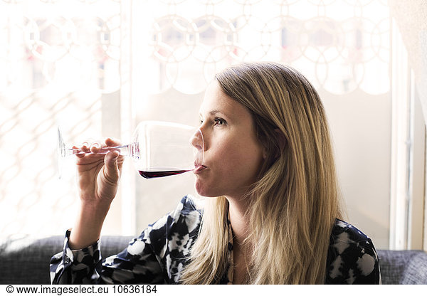 Woman drinking red wine at Lebanese restaurant