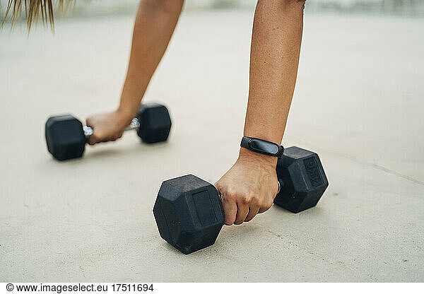 Woman during workout with dumbbells