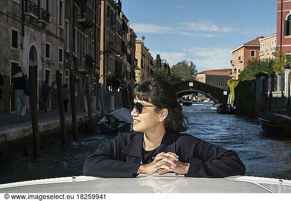 woman enjoying a boat taxi ride in Venice