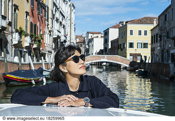 woman enjoying a boat taxi ride in Venice