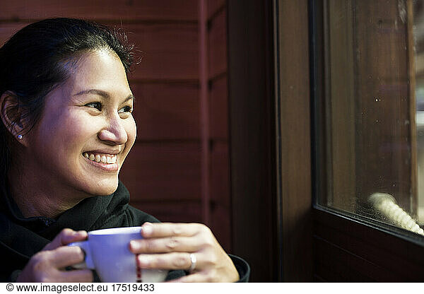 woman enjoying a hot beverage at cafe in France