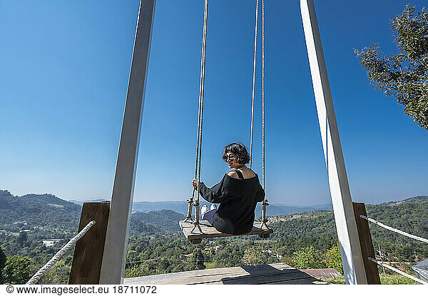 woman enjoying a rope swing in the hills of Chiang Rai