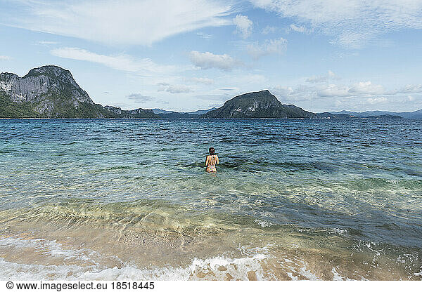 Woman enjoying amidst sea at vacation