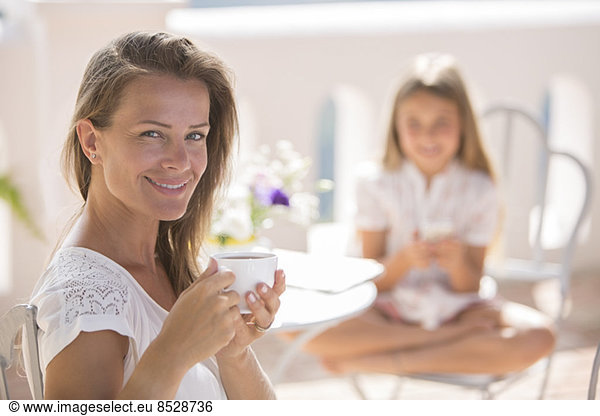 Woman enjoying cup of coffee outdoors