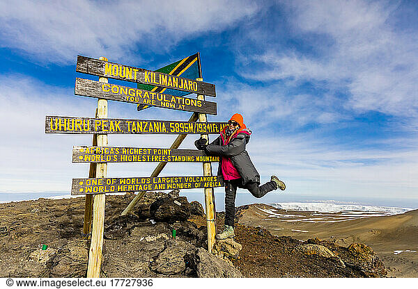 Woman excited she made it to Uhuru Peak on Mount Kilimanjaro  UNESCO World Heritage Site  Tanzania  East Africa  Africa