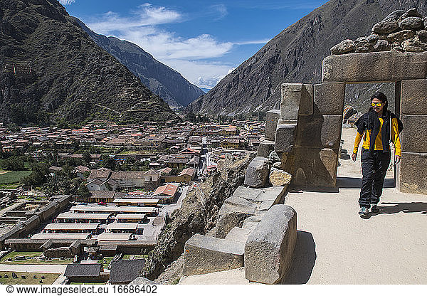 Woman exploring Inca ruins above Ollantaytambo  Peru
