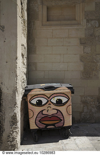Woman face painted on garbage bin  Puglia  Italy