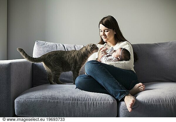 Woman feeding child couch