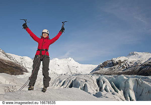 woman feeling victorious on the Fjallsjökull glacier in Iceland