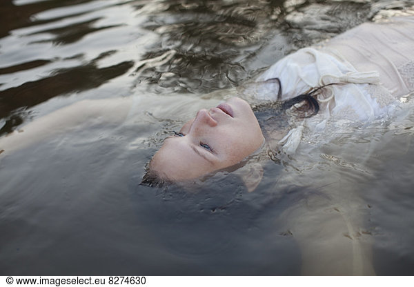 Woman floating in lake