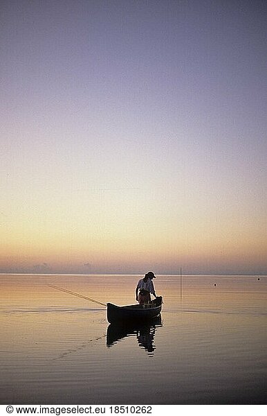 Woman fly fishing with a canoe in the Florida Keys