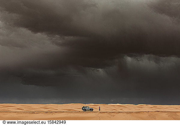 woman gets out of jeep to take pictures of microburst in utah desert