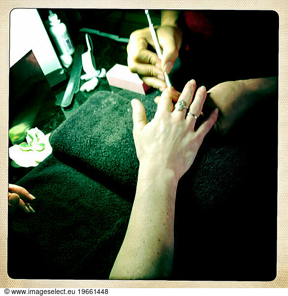 Woman getting manicure