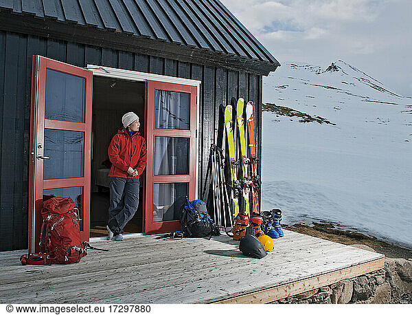 Woman getting ready for ski touring at ski cottage in Iceland